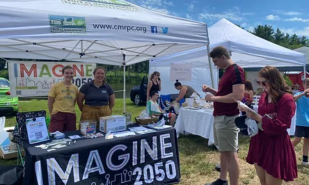 People at an Imagine 2050 event booth